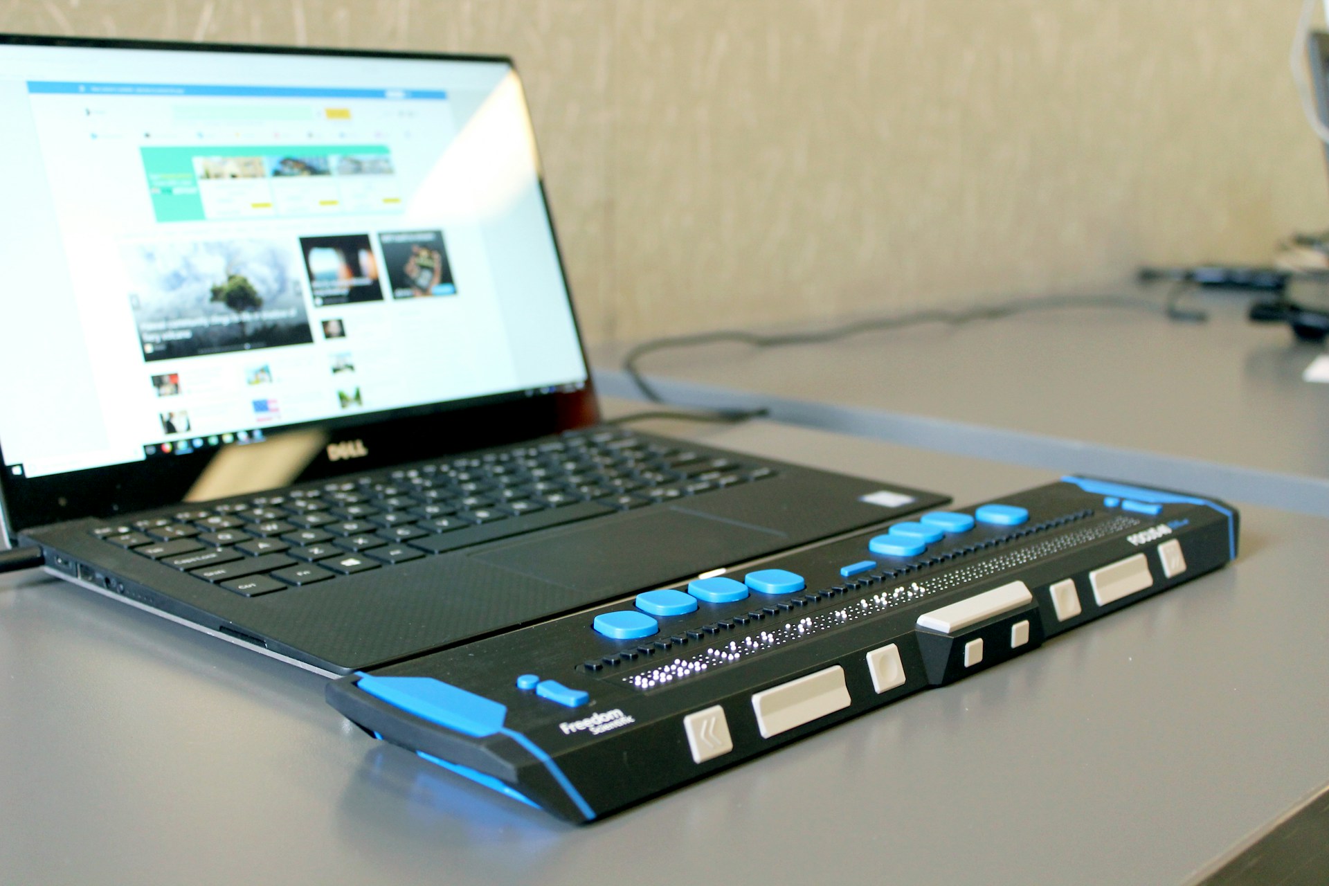 Refreshable Braille Display connected to a black laptop: